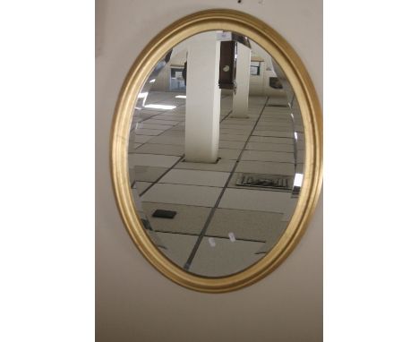 A MODERN OVAL MIRROR