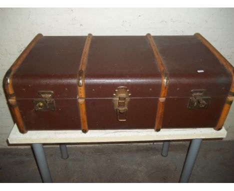 A BROWN WOODEN BRANDED TRAVEL TRUNK WITH INNER TRAY