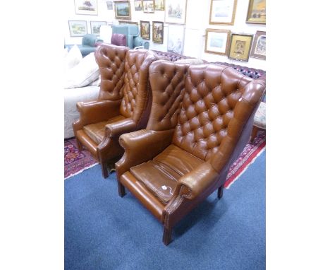 A PAIR OF TAN LEATHER BUTTON BACK WING BACK ARMCHAIRS