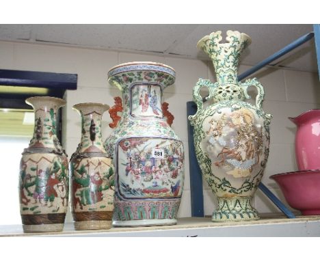 A COLLECTION OF ORIENTAL VASES, comprising a pair of baluster vases, fighting figures with relief moulding, five character ma