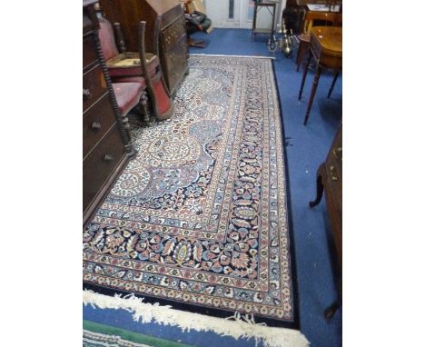 A LARGE BLUE GROUND FLORAL PATTERNED 100% ACRYLIC CARPET, 'Saray Hali' Made in Turkey label attached, approximate size 400cm 
