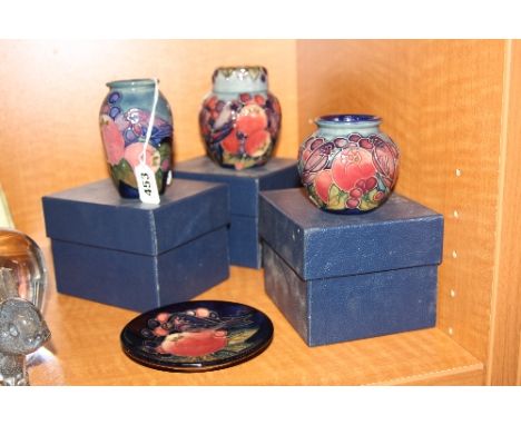 FOUR PIECES OF MOORCROFT POTTERY, Finches & Fruit design, to include ginger jar height approximately 11cm, two vases heights 