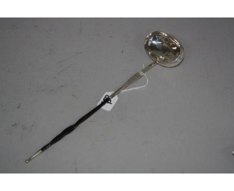 A LADLE WITH SILVER BOWL, having monogram under scroll engraving to mount with twisted ebonised handle, hallmark rubbed, appr