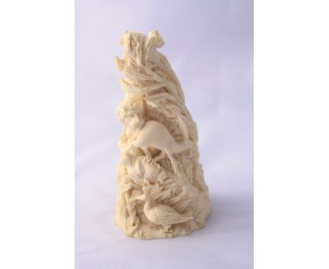 A CARVED STATUTE OF A LION HUNTING PREY