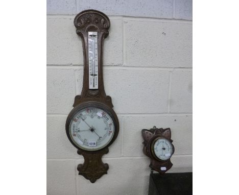 A CARVED OAK CASED ANEROID BAROMETER, and a smaller barometer (2)