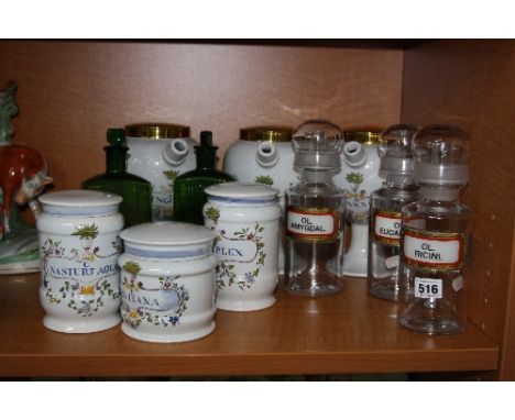 APOTHERARY JARS, to include clear glass lidded spouted OL.AMYGDAL, OL.EUCALYPT, OL, RICINI, approximately 24cm high, together