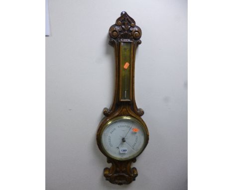 A CARVED OAK FRAMED BAROMETER, dial marked Heap, Burnley