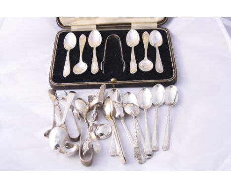 A CASED SET OF SIX SILVER TEASPOONS, with shell terminals and a set of tongs, Birmingham 1919, six deco style silver teaspoon