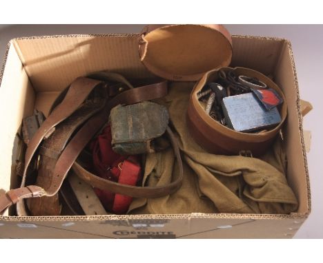 A BOX OF WW1 ERA MILITARIA, to include uniforms items, leather belts webbing etc, shirt/coverall blouse, together with circul