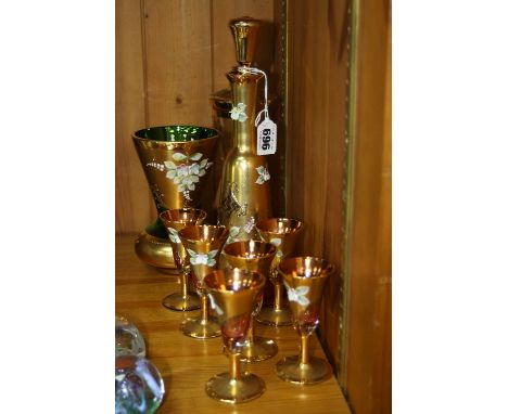 A BOHEMIA GLASS DECANTER AND GLASSES SET, ruby glass with gilt decoration and embossed flowers (7), together with two similar