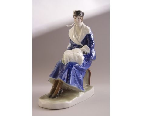 A FRAUREUTH KNUSTABTEILUNG FIGURINE, seated lady in fur trim coat and muff, factory backstamp