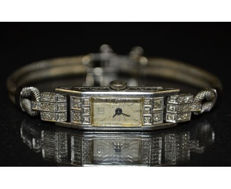 An Art Deco lady's platinum and diamond cocktail watch, rectangular case, inset to each end with five round brilliant cut dia