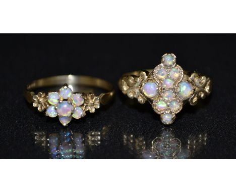 An opal cluster ring, shaped central lozenge inset with ten round opals, flashing blue, green and red colour play, 9ct gold s