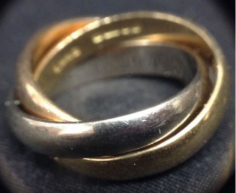 An modern design 18ct gold two colour triple band ring, three individual interconnected yellow and white gold bands, size M, 