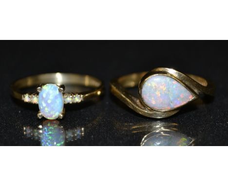 A teardrop opal ring, side mounted teardrop opal, flashing red, orange, blue and green colour play, 9ct gold shank, size P, 3