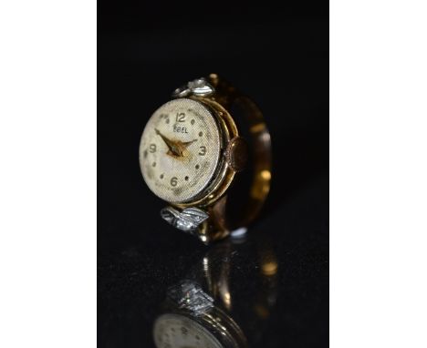 Ebel - a lady's diamond mounted yellow metal ring watch, circular silvered dial, quartered Arabic numerals, dot batons, manua