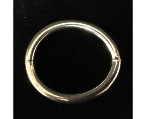 A 9ct gold invisible hinge slave bangle, compression clasp, stamped 375, 29.3g gross