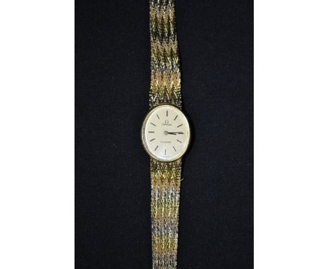 Omega - a Lady's bracelet watch, oval cream dial, baton markers, quartz movement, fancy 18ct three colour gold integral strap
