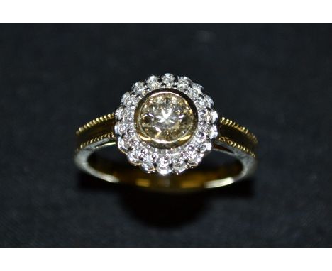 A natural Argyle nineteen stone diamond ring, central champagne Argyle diamond, approx 0.50ct, SI clarity, surrounded by a ba