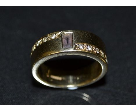 A diamond and pink sapphire eleven stone band ring, central rectangular baguette cut pink sapphire, flanked to each side by a