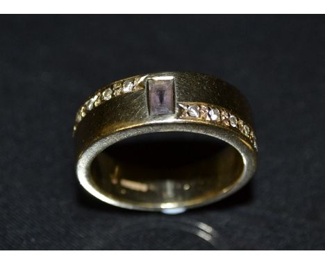 A diamond and pink sapphire eleven stone band ring, central rectangular baguette cut pink sapphire, flanked to each side by a