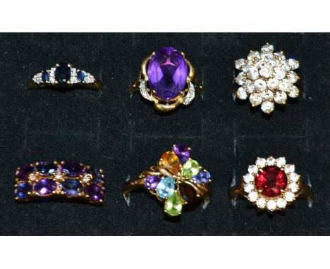 A 9ct gold multi stone dress ring, set with an array of gem stones including peridot, garnet, amethyst etc, 9ct gold shank, s