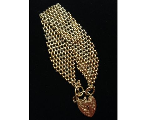 A 9ct gold two tone yellow and white arrow head pattern articualted chain link bracelet, united by an engraved padlock clasp,