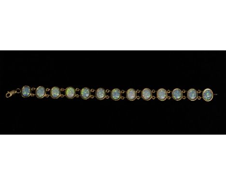 A thirteen panel opal bracelet, each oval opal flashing green, blue, orange, and red colour play, double loop link 9ct gold f