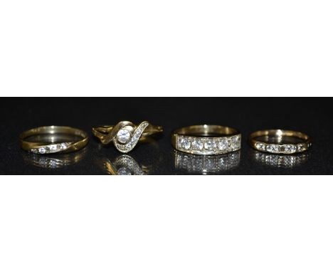 A five stone cubic zirconia dress ring, five round cut stones linear set to a white platform, 9ct gold shank, size M;  others