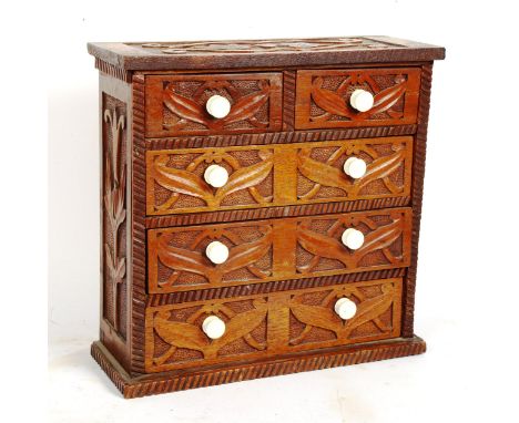 An Arts and Crafts oak table-top chest of drawers, with white ceramic knobs, height 32cm 
