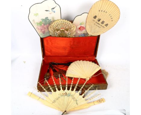 A tan leather suitcase, containing various fans, including ivory and lacquer 