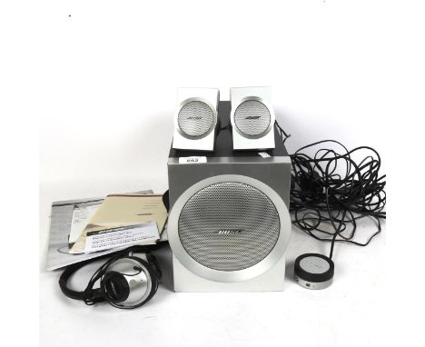 A Bose Companion 3 multimedia speaker system, and a pair of Bose around-ear headphones, with instructions 