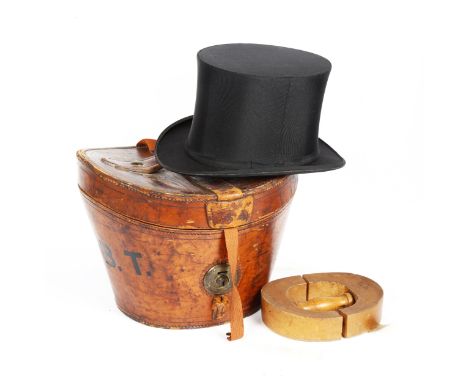 A Vintage black top hat, by Bates of London, in Victorian brown leather hat box by J W Allen