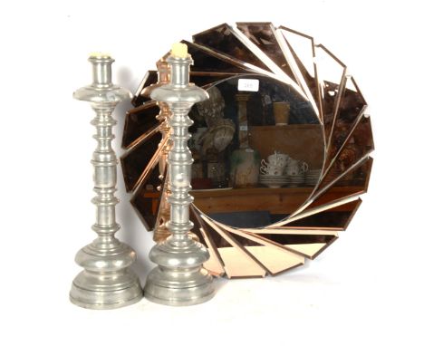 An Art Deco style peach and clear glass circular wall mirror, and a large pair of Spanish pewter candlesticks, height 44cm (2