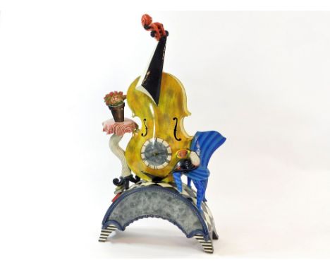 ROSS EMERSON. A Ross Emerson hand built ceramic mantel clock featuring a violin, a toucan on a chair & a pot plant on a table