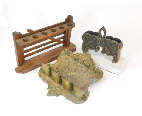 PIPE RACKS. A brass wall-hung & a wooden gate pipe rack. Also, a cast metal matches & cigarette desk stand on a marble base. 