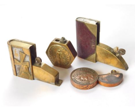 NOVELTY POCKET LIGHTERS ETC. Two novelty book lighters, a Napoleon III coin lighter & a hexagonal Art Nouveau lighter. (4). N
