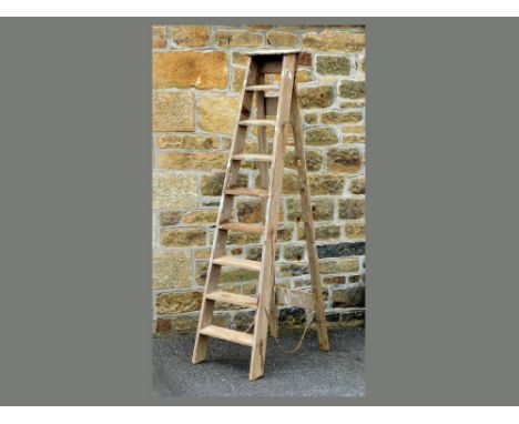 FOLDING STEP LADDER. A vintage pine 8-rung wooden folding step ladder. Height 216cm.  Please note that all items in this auct