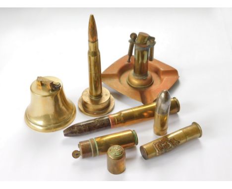 TRENCH ART LIGHTERS. Two WWII 'trench art' lighters made from a cannon shell, length 178mm & 138mm (without plinth); three ot