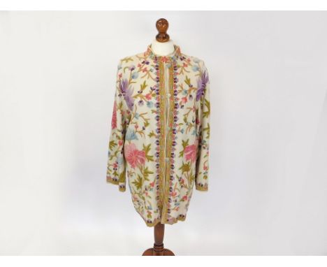 KASHMIRI COAT. A Kashmiri vintage wool coat with all-over crewel work embroidery. Lined in cotton. Full length 83cm. Width un