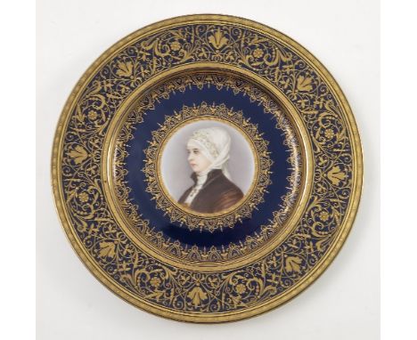 A late 19th/early 20th Viennese plate, decorated with a bust portrait of a young girl wearing a headscarf and a crucifix, to 