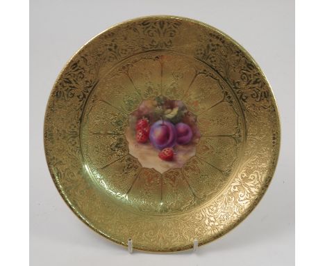 A Royal Worcester cabinet plate, decorated with a central panel of hand painted fruit by Price, to a deep acid gilt border, d