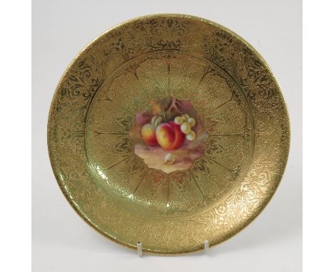 A Royal Worcester cabinet plate, decorated with a central panel of hand painted fruit by Price, to a deep acid gilt border, d