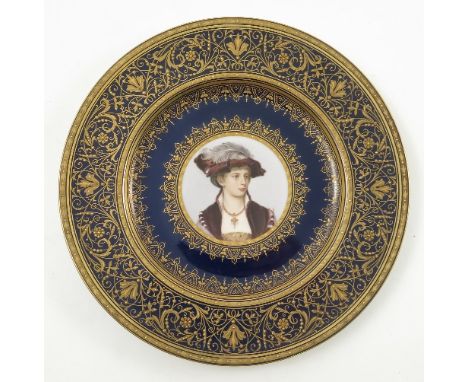 A late 19th/early 20th Viennese plate, decorated with a bust portrait of a young girl with feathered hat and pendant with pea