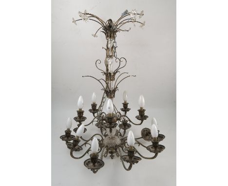 A large gilt metal light fitting, having fifteen lights over two tiers, decorated with glass flowers, droppers, swags and bal