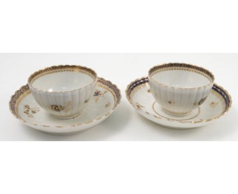 A pair of late 18th century Caughley tea bowls and saucers, with gadrooned body and gilt and blue decoration, S mark to base 