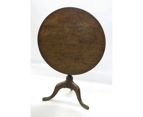 A late Georgian oak circular occasional table, raised on a turned column, terminating in a tripod base, width 32ins 