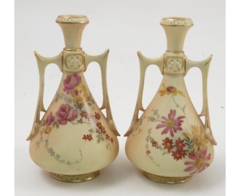 A pair of Royal Worcester blush ivory two handled vases, decorated with floral sprays, shape numbers 1021, height 6ins Condit