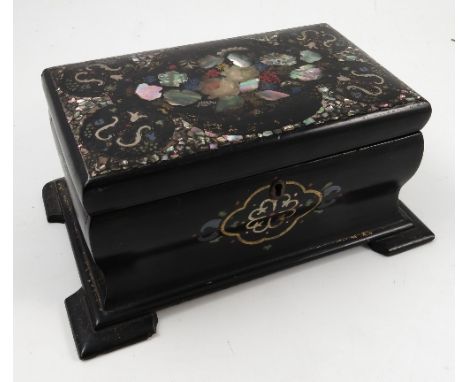 A 19th century black papier mache tea caddy, the cover decorated with inlaid mother of pearl, with shaped body, the interior 