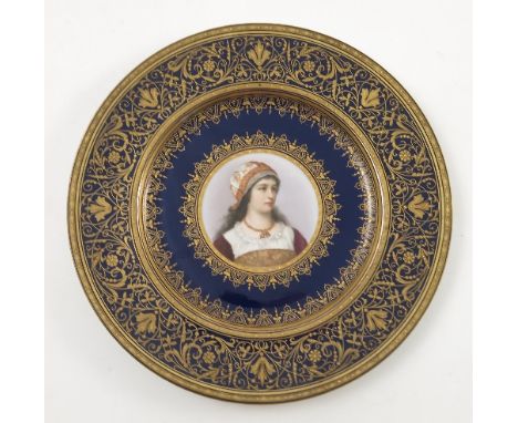 A late 19th/early 20th Viennese plate, decorated with a bust portrait of a young girl wearing floral patterned scarf and a ne